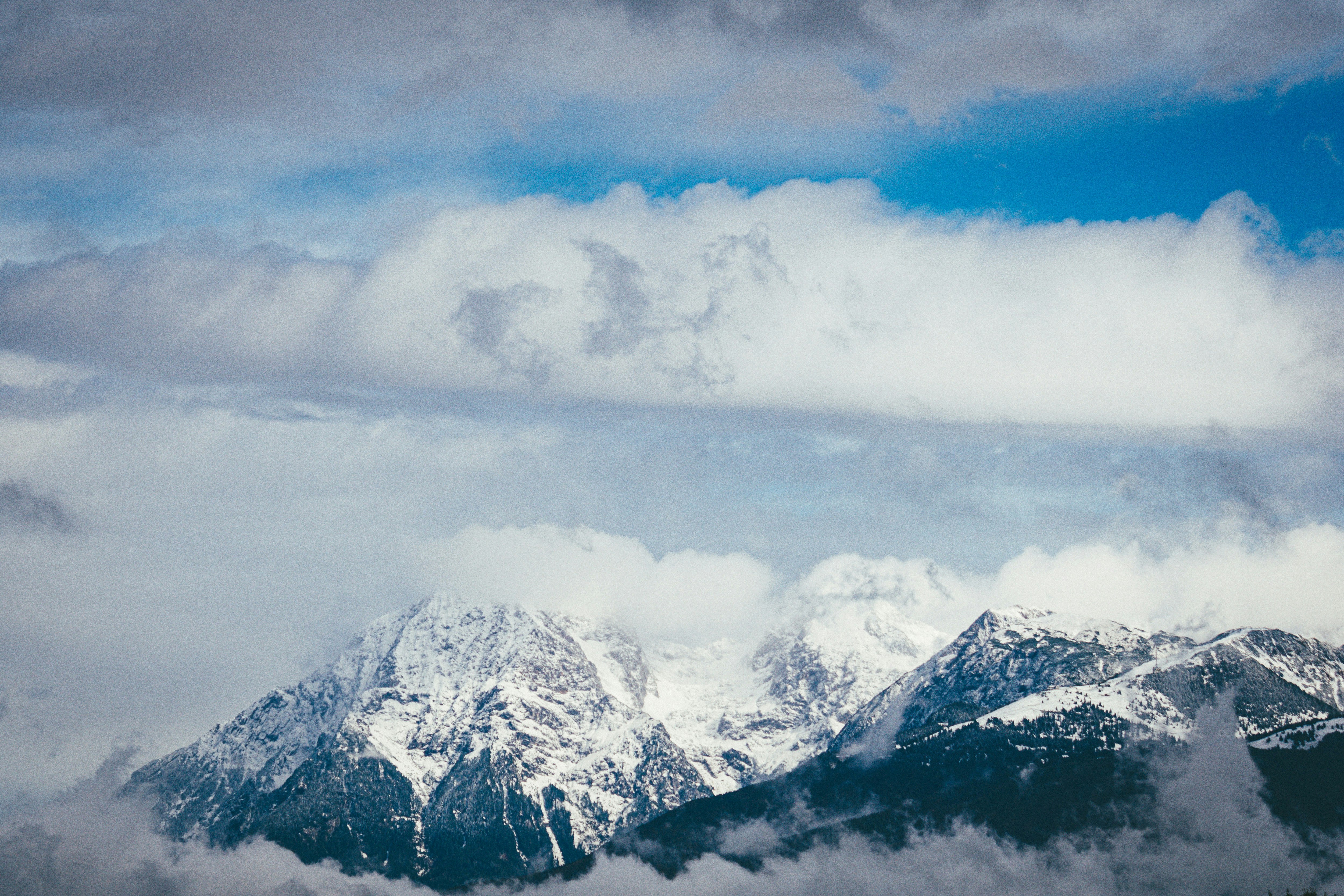 snow covered mountain under cloudy sky during daytime